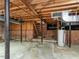 Unfinished basement with exposed brick, wood ceiling and structural supports, and utility connections at 2434 Morningside Dr, Burlington, NC 27217