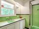 This bathroom features vintage tiling, bright natural light, and a shower with sliding glass door at 2434 Morningside Dr, Burlington, NC 27217