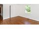 Bright bedroom with hardwood floors, fresh white paint, and a closet at 2434 Morningside Dr, Burlington, NC 27217