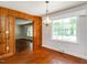 Inviting dining room featuring wood paneled walls and hardwood floors at 2434 Morningside Dr, Burlington, NC 27217