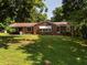 Charming single-story brick home with a well-manicured lawn and mature trees at 2434 Morningside Dr, Burlington, NC 27217