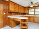 Well-lit kitchen with wooden cabinets, custom island, and modern ceiling fan at 2434 Morningside Dr, Burlington, NC 27217