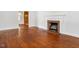 Warm living room featuring a fireplace, hardwood floors, and an open doorway to the next room at 2434 Morningside Dr, Burlington, NC 27217