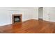 Cozy living room showcasing hardwood floors, a brick fireplace, and a classic white mantel at 2434 Morningside Dr, Burlington, NC 27217