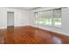 Spacious living room featuring hardwood floors, large windows, and neutral paint colors at 2434 Morningside Dr, Burlington, NC 27217