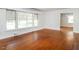 Bright living room with gleaming hardwood floors and large windows offering ample natural light at 2434 Morningside Dr, Burlington, NC 27217
