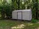 A storage shed is nestled among the trees at 2434 Morningside Dr, Burlington, NC 27217