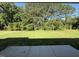A spacious green lawn extends to a lush tree line, offering a serene outdoor space at 245 Eason Creek Way, Clayton, NC 27527