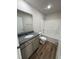 This bathroom features a granite countertop, wood-look flooring, and white bathtub and shower combo at 245 Eason Creek Way, Clayton, NC 27527