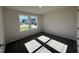 This bedroom features a large window bringing in natural light and soft neutral carpeting at 245 Eason Creek Way, Clayton, NC 27527