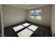This bedroom features a large window bringing in natural light and soft neutral carpeting at 245 Eason Creek Way, Clayton, NC 27527