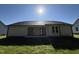 A bright backyard showing the home's exterior with a patio and grassy lawn at 245 Eason Creek Way, Clayton, NC 27527