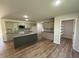 Modern kitchen with granite countertops, stainless steel appliances, an island, and tile backsplash at 245 Eason Creek Way, Clayton, NC 27527