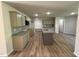 Modern kitchen featuring an island, stainless appliances, granite countertops, and ample cabinet space at 245 Eason Creek Way, Clayton, NC 27527