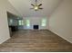 Bright open-concept living space with modern wood flooring and a charming fireplace at 245 Eason Creek Way, Clayton, NC 27527