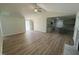 Open-concept with wood flooring, ceiling fan and sliding glass doors, adjacent to kitchen at 245 Eason Creek Way, Clayton, NC 27527