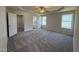 Spacious main bedroom with tray ceiling, ceiling fan, and adjacent ensuite bath and walk-in closet at 245 Eason Creek Way, Clayton, NC 27527