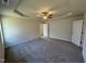 Large main bedroom with tray ceiling, ceiling fan and views of the walk-in closet and ensuite bath at 245 Eason Creek Way, Clayton, NC 27527