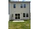 This home's backyard features a sliding glass door to a patio, and a well-maintained lawn at 253 Hank Way, Angier, NC 27501