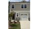 Charming two-story home features a front-entry garage, neutral siding, and a well-maintained lawn and landscaping at 253 Hank Way, Angier, NC 27501