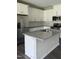 Modern kitchen with white cabinets, stainless steel appliances, an island with a sink, and granite countertops at 253 Hank Way, Angier, NC 27501