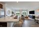 Open-concept living space featuring hardwood floors, large windows, and an adjacent kitchen with a granite island at 253 Hank Way, Angier, NC 27501