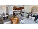 Spacious living area with hardwood floors, a modern sofa, a kitchen, and ample natural light at 253 Hank Way, Angier, NC 27501