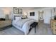 Bright main bedroom featuring white bedding, soft carpet, decorative wall art and stylish furnishings at 253 Hank Way, Angier, NC 27501