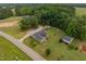 Aerial view of the property, showing the main residence, outbuildings, and expansive green lawn at 2646 Laurel Mill-Centerville Rd, Louisburg, NC 27549