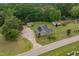 Aerial view of a home with solar panels surrounded by lush greenery and mature trees at 2646 Laurel Mill-Centerville Rd, Louisburg, NC 27549