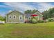 Exterior view of the home's backyard, with stairs and a glimpse of outdoor living spaces at 2646 Laurel Mill-Centerville Rd, Louisburg, NC 27549