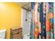 Shower with colorful floral shower curtain and additional storage unit at 2646 Laurel Mill-Centerville Rd, Louisburg, NC 27549