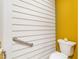 Toilet and grab bar in bathroom with yellow and white walls at 2646 Laurel Mill-Centerville Rd, Louisburg, NC 27549