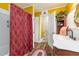 Bathroom with wood floors, shower with red curtain, vanity, and cabinet at 2646 Laurel Mill-Centerville Rd, Louisburg, NC 27549