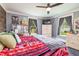 Comfortable bedroom with gray walls and bright windows, dresser, and television at 2646 Laurel Mill-Centerville Rd, Louisburg, NC 27549