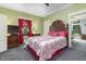 Charming bedroom with a decorative headboard, red accents, and natural light from the nearby window at 2646 Laurel Mill-Centerville Rd, Louisburg, NC 27549