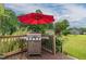 Outdoor deck featuring a stainless steel grill and a red umbrella for shade at 2646 Laurel Mill-Centerville Rd, Louisburg, NC 27549