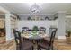 Elegant dining room with a modern chandelier, decorative wall, and glass table at 2646 Laurel Mill-Centerville Rd, Louisburg, NC 27549