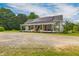 Charming home with a covered front porch, solar panels, and well-maintained landscaping at 2646 Laurel Mill-Centerville Rd, Louisburg, NC 27549