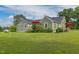 Charming home with a well-manicured lawn and inviting red umbrellas, ideal for outdoor enjoyment at 2646 Laurel Mill-Centerville Rd, Louisburg, NC 27549