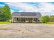 Charming home with a welcoming front porch and solar panels on the roof at 2646 Laurel Mill-Centerville Rd, Louisburg, NC 27549