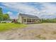 Exterior view of home showcasing solar panels, porch, and spacious yard at 2646 Laurel Mill-Centerville Rd, Louisburg, NC 27549