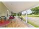 Spacious porch with seating for outdoor enjoyment and views of the surrounding landscape at 2646 Laurel Mill-Centerville Rd, Louisburg, NC 27549