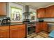 Stylish kitchen featuring stainless steel appliances, updated range hood, and custom wood cabinets at 2646 Laurel Mill-Centerville Rd, Louisburg, NC 27549
