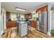 Well-lit kitchen featuring stainless steel appliances, an island with seating, and custom wood cabinetry at 2646 Laurel Mill-Centerville Rd, Louisburg, NC 27549