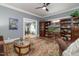Spacious living room with wooden shelving, a decorative rug, and natural light at 2646 Laurel Mill-Centerville Rd, Louisburg, NC 27549
