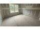 Unfinished bedroom with a large window overlooking the backyard at 2760 Rains Mill Rd, Princeton, NC 27569