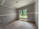 Bright bedroom featuring a large window offering views of the outdoors, creating a serene and relaxing space at 2760 Rains Mill Rd, Princeton, NC 27569