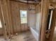 Bathroom with wood-frame construction, window, and modern tub at 2776 Rains Mill Rd, Princeton, NC 27569