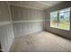 An unfinished bedroom features drywall and a single window overlooking the backyard at 2776 Rains Mill Rd, Princeton, NC 27569